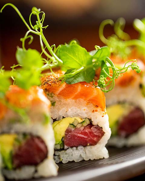 Detail shot of a sushi roll with micro greens